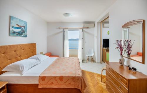 a bedroom with a bed and a view of the ocean at Villa Jana in Marusici 