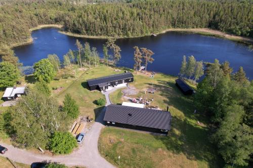 an aerial view of a house next to a lake at Gråbogården event and conference center in Gråbo