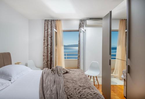 a bedroom with a bed and a view of the ocean at Villa Jana in Marusici 