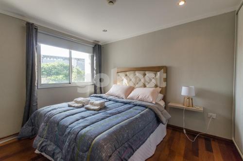 a bedroom with a bed with a large window at Ample 2 Bedroom Close To Shopping Del Sol in Asuncion