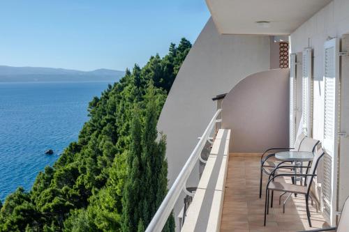 a balcony with chairs and a view of the ocean at Villa Jana in Marusici 