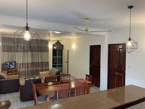 a dining room and living room with a table and chairs at Wonder Homestay in Negombo