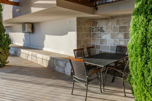 a black table and chairs on a patio at Villa Jana in Marusici 