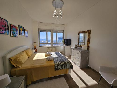 a bedroom with a bed and a dresser and a mirror at La Finestra sul Porto in Genova