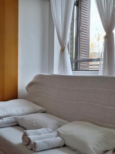 a bed with towels on it with a window at RIVIJERA GREEN in Belgrade