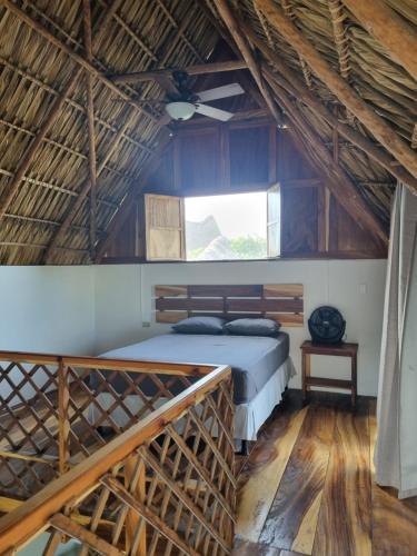 a bedroom with a bed and a window at Gecko Hotel in El Paredón Buena Vista