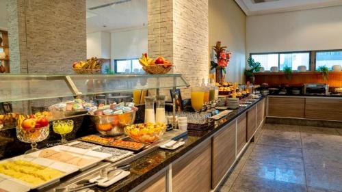 a buffet line with a lot of food on display at Betel Beach Flat Boa Viagem in Recife