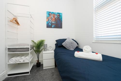 a bedroom with a blue bed in a room at HORNSEY LODGE - Strictly NO Parties in Liverpool