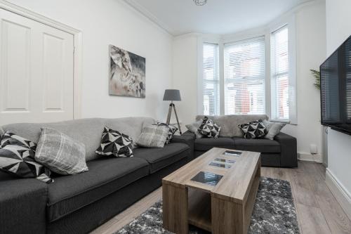a living room with a couch and a coffee table at Hornsey Lodge - Anfield Apartments in Liverpool