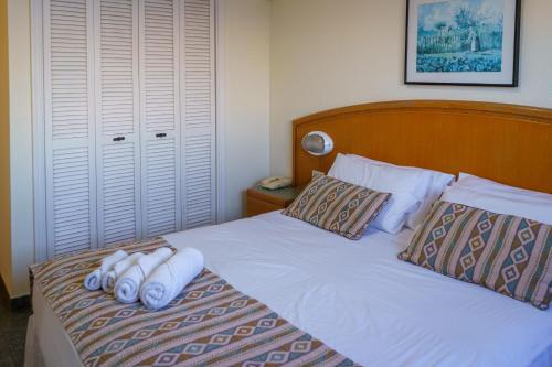 a bedroom with a bed with towels on it at Hostal del Sol in San Bernardo