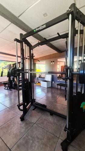 a fitness room with a gym with at Hotel Vila Nova in Teresópolis