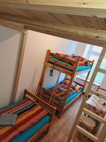 two bunk beds in a room with wooden floors at Relax Rooms & Apartments Vienna Belvedere 10 minutes to downtown in Vienna