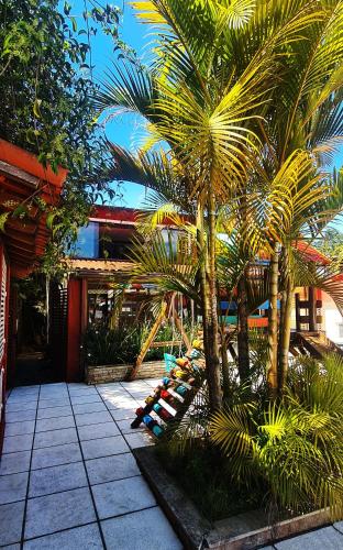 a group of palm trees in front of a building at Hotel Vila Nova in Teresópolis