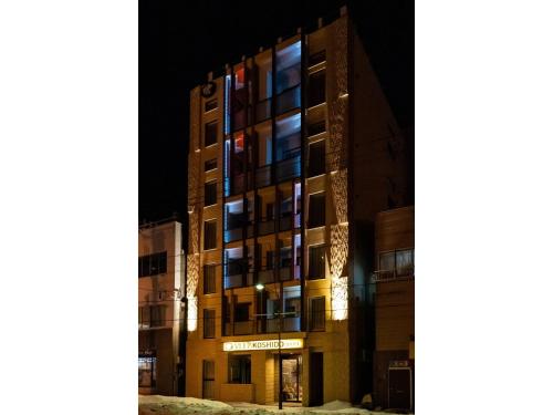 an apartment building at night with the lights on at VILLA KOSHIDO ODORI - Vacation STAY 04745v in Sapporo