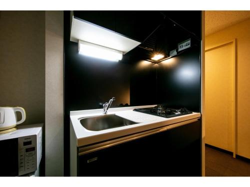 a kitchen with a sink and a stove at VILLA KOSHIDO ODORI - Vacation STAY 04745v in Sapporo