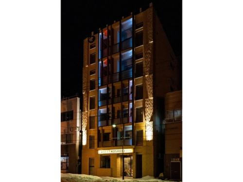 a tall building at night with the lights on at VILLA KOSHIDO ODORI - Vacation STAY 04745v in Sapporo