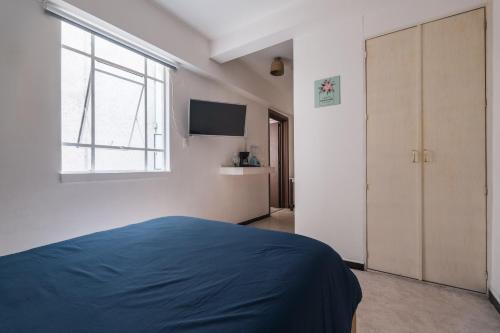a bedroom with a blue bed and a window at affordable little private room, Polanco :) in Mexico City