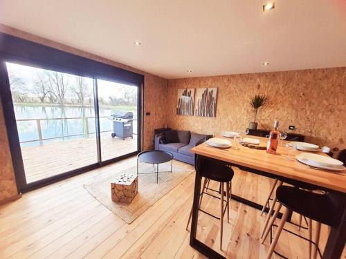 une cuisine et un salon avec une grande fenêtre dans l'établissement Chalet les pieds dans l'eau la campagne à la ville, à Saint-Doulchard