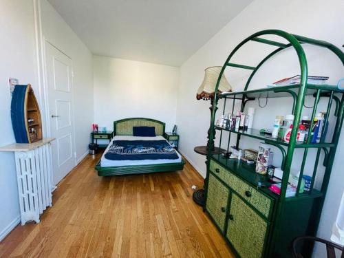 a bedroom with a green bunk bed and a wooden floor at Stay in Royal versailles! in Versailles