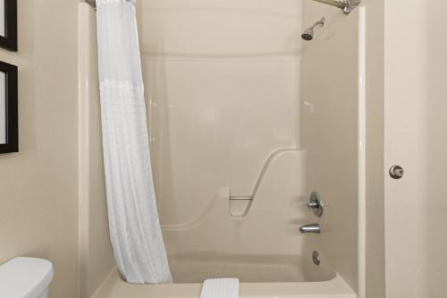 a bathroom with a shower with a shower curtain at Comfort Suites Kansas City-Liberty in Liberty