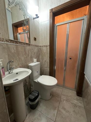 a bathroom with a toilet and a sink and a mirror at Konak Kardelen in Yıldırım