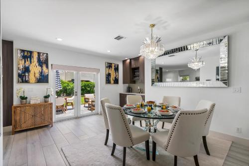 a dining room and living room with a table and chairs at Elegant 3BR w Pool Near Downtown WPB in West Palm Beach