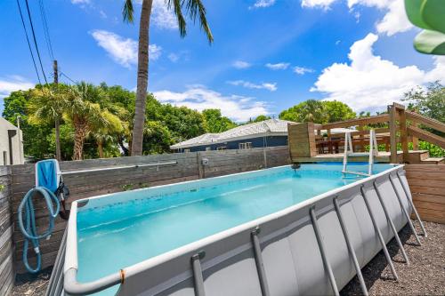 a swimming pool with a wooden fence around it at Elegant 3BR w Pool Near Downtown WPB in West Palm Beach