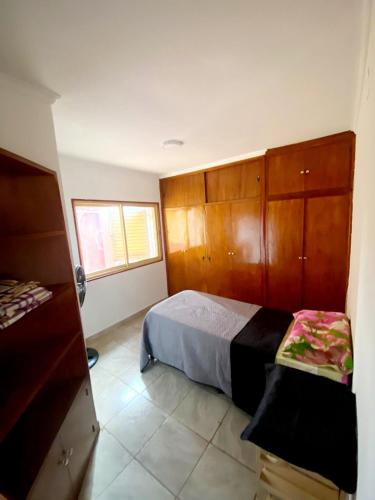 a bedroom with a bed and wooden cabinets at Posadas Aloja in Posadas