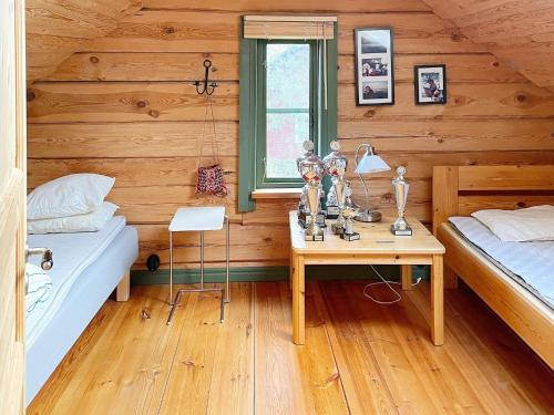 a bedroom with two beds and a desk and a window at Holiday home YNGSJÖ II in Yngsjö