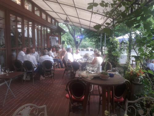 a group of people sitting at tables on a patio at Augustusgabe Barby in Barby