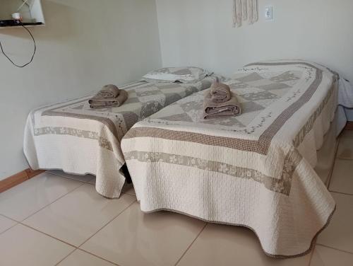 łóżko z ręcznikami na górze w pokoju w obiekcie Casa da Tôta w mieście São João Batista do Glória