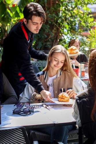 a man and a woman sitting at a table with a plate of food at Comfort Suites in Alanya