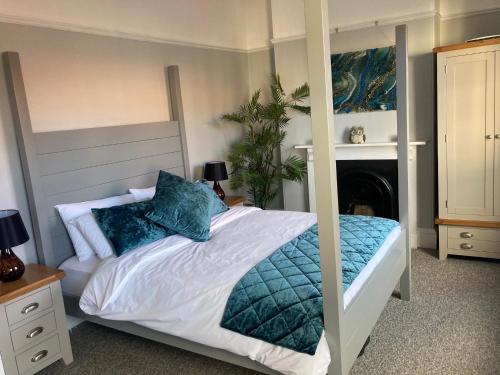 - une chambre avec un grand lit et des oreillers bleus dans l'établissement Stylish Flat in Yeovil Somerset, à Yeovil