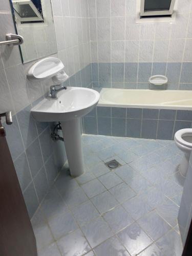 a bathroom with a sink and a toilet at ORIENT TOWER in Ajman 