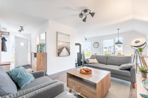 a living room with two couches and a table at Ferienwohnung Nicks Seestern Olpenitz in Olpenitz