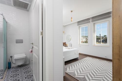 a white bathroom with a sink and a toilet at Villa Capital in Dalyan