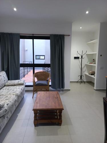 a living room with a couch and a coffee table at El Trébol II in Necochea