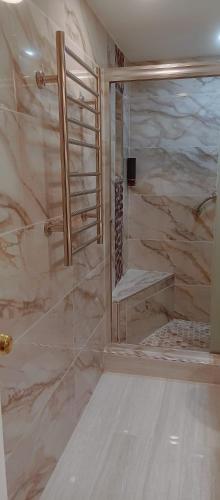 a bathroom with a walk in shower with a bench at Ocean Reserve in Sunny Isles Beach