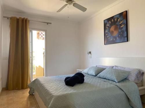 a bedroom with a bed and a ceiling fan at Amazing Penthouse in Los Cristianos