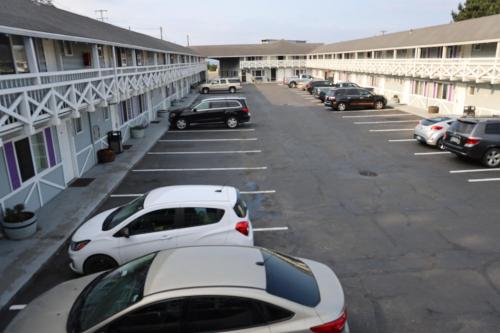 a row of cars parked in a parking lot at Global Inn in Coos Bay
