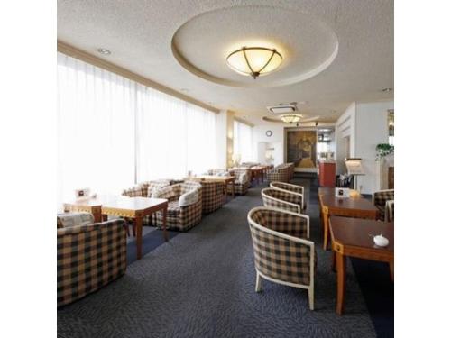 a dining room with chairs and tables and a room with at Zentsuji Grand Hotel - Vacation STAY 16629v in Zentsuji