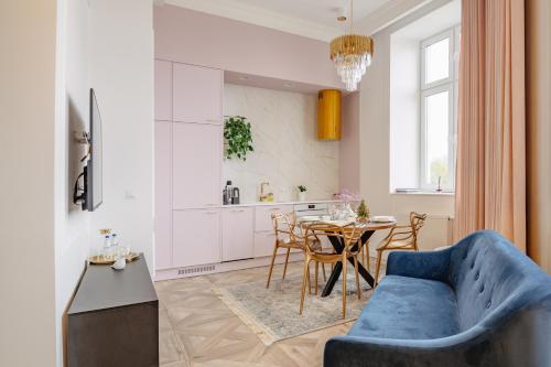 uma sala de estar com um sofá azul e uma mesa em Urso Apartament Premium em Przemyśl