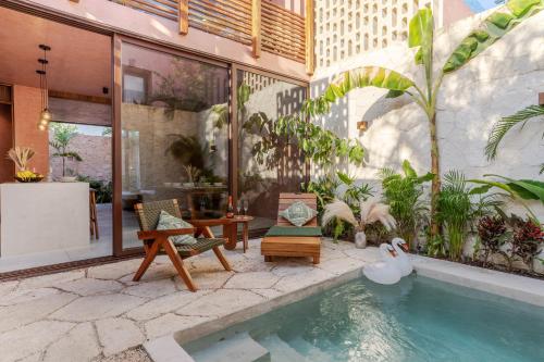 a house with a swimming pool with chairs and plants at Entorno Tulum - Luxury Villas in Tulum