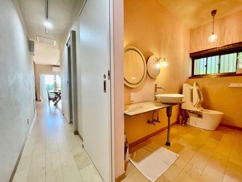a bathroom with a sink and a mirror at Yoronto - Vacation STAY 18850v in Yoron