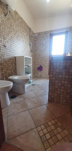 a bathroom with a toilet and a sink at Al Rifugio in Montecorvino Pugliano