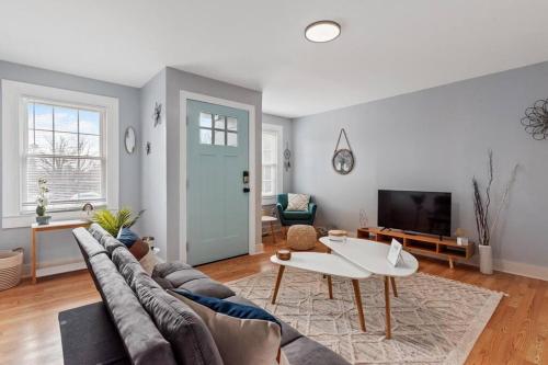 a living room with a couch and a table at BOHO BUNGALOW - STEPS FROM HISTORIC DOWNTOWN APEX in Apex