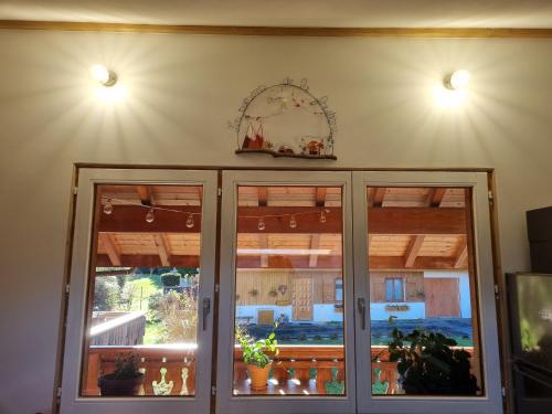 a room with two glass doors and a window at Appartement 4 personnes Lac d'Annecy in Lathuile