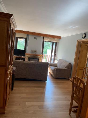 a living room with a couch and a table at Piso en el port del comte in La Coma i la Pedra