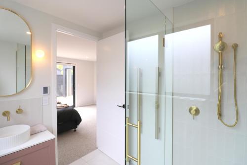 a bathroom with a shower and a sink at Urban Cube in Invercargill