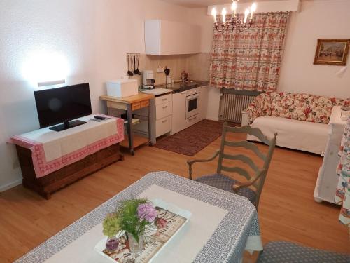 a kitchen and a living room with a table and a kitchen and a living room at Ferienwohnung Grünwald in Grünwald